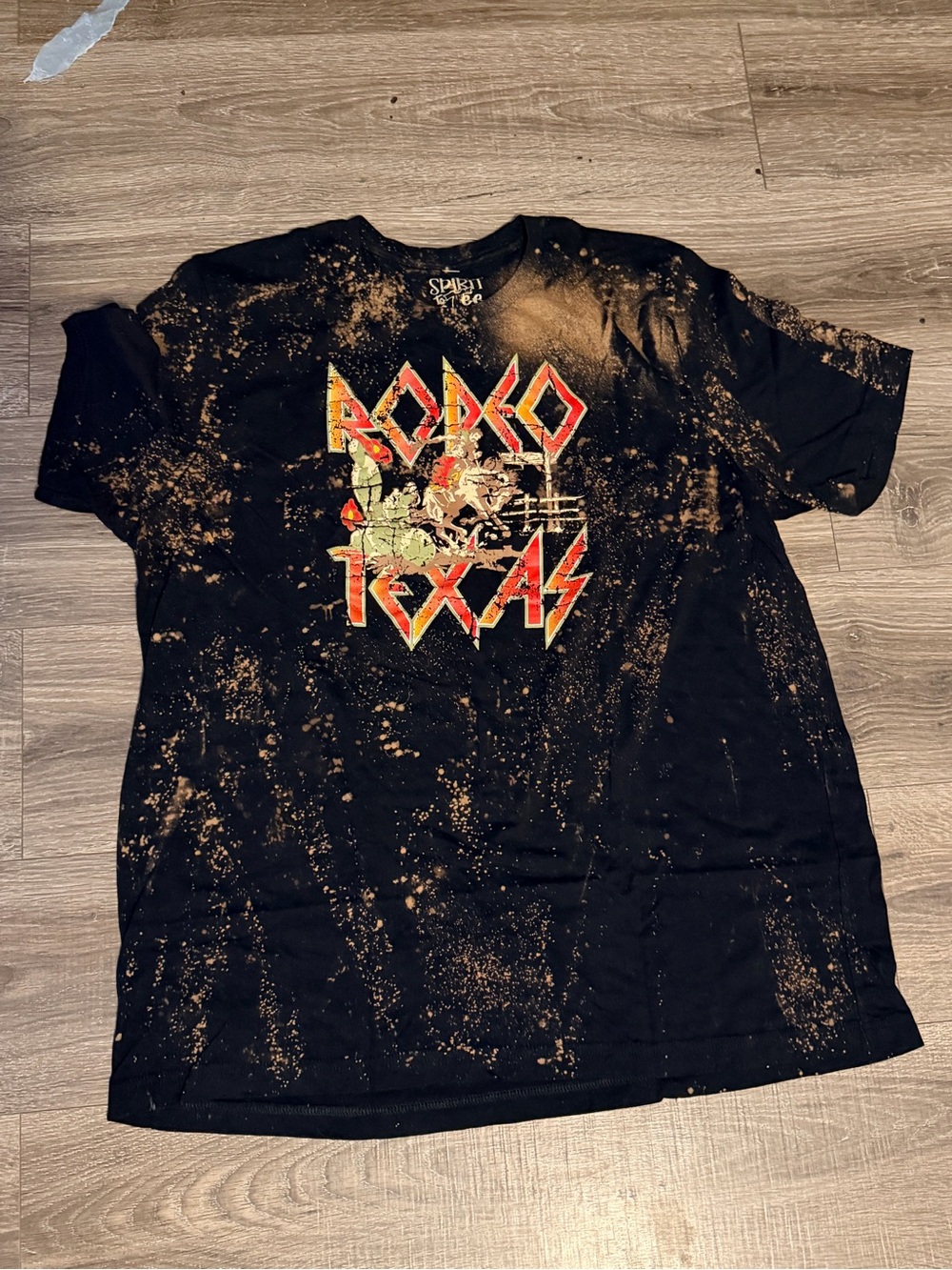 Spirit Acid-Wash Black Tee with Orange and Red Rodeo Graphic